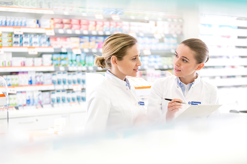 Pharmacists talking in pharmacy